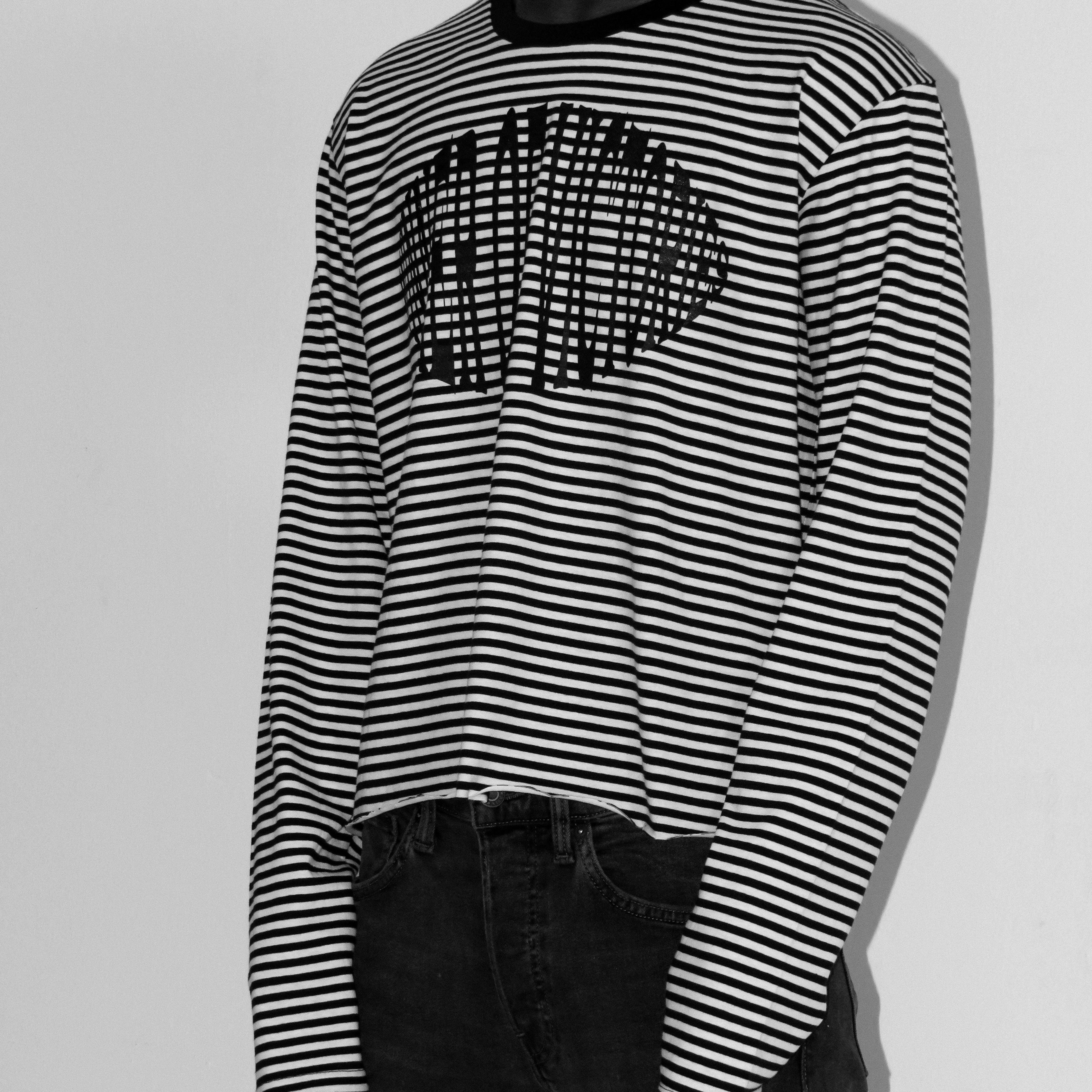 Black and white striped long-sleeve T-shirts with graphic design on a gray background