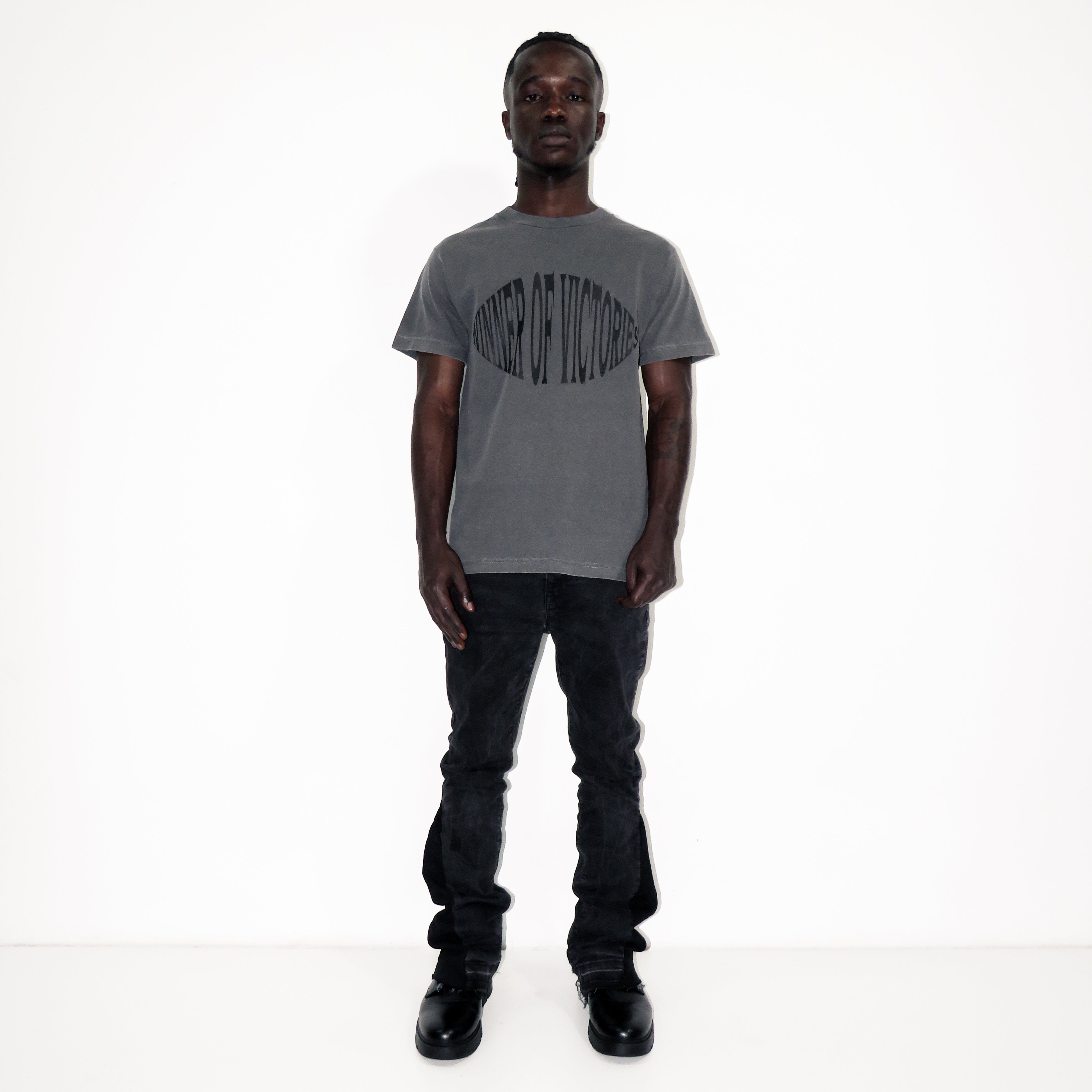 Man wearing a gray t-shirt with a graphic design on a white background