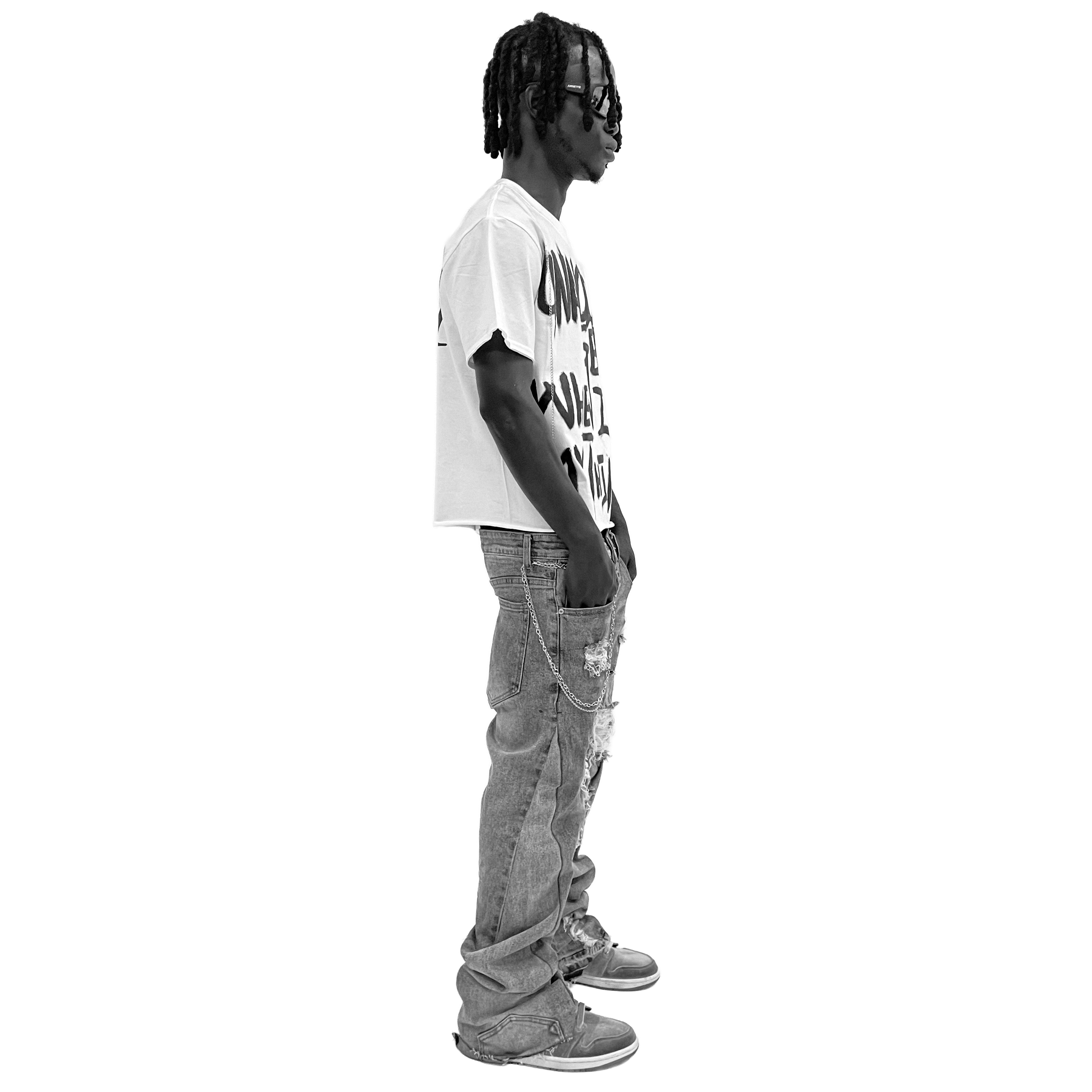 Person wearing a white t-shirt with text and gray pants on a white background