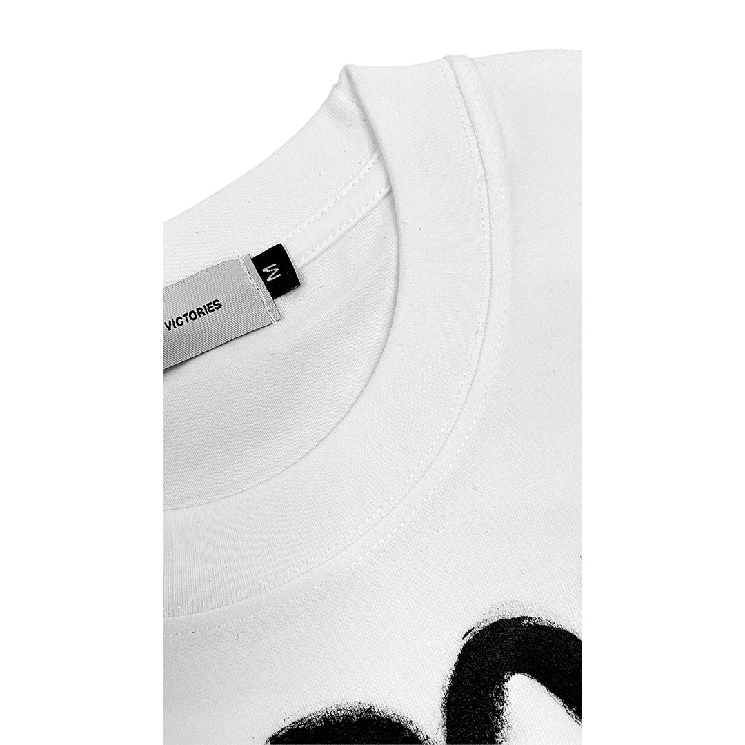 White garment with a black and white design and a visible label on a white background